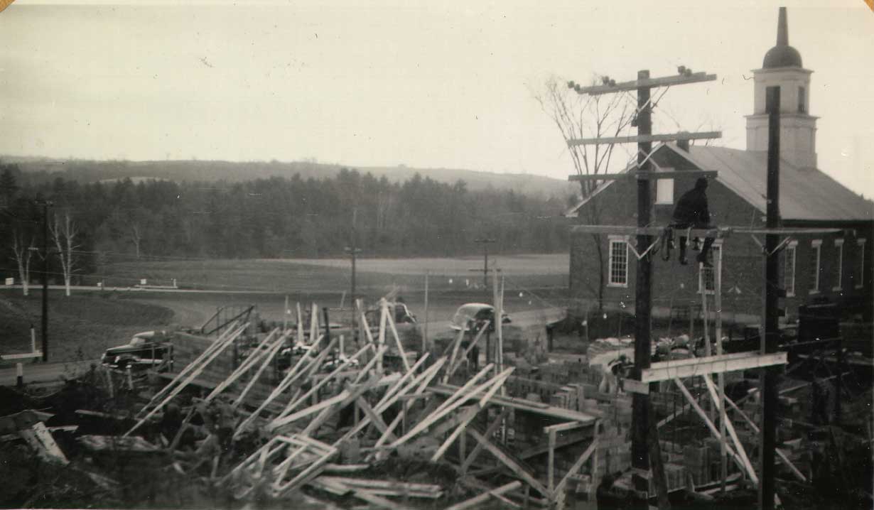 Marshall Hodgeman, a longtime member of the church who worked for Washington Electric Coop in its early days, sits on the substation watching the tanks put in place. This picture was taken in late November, 1939.